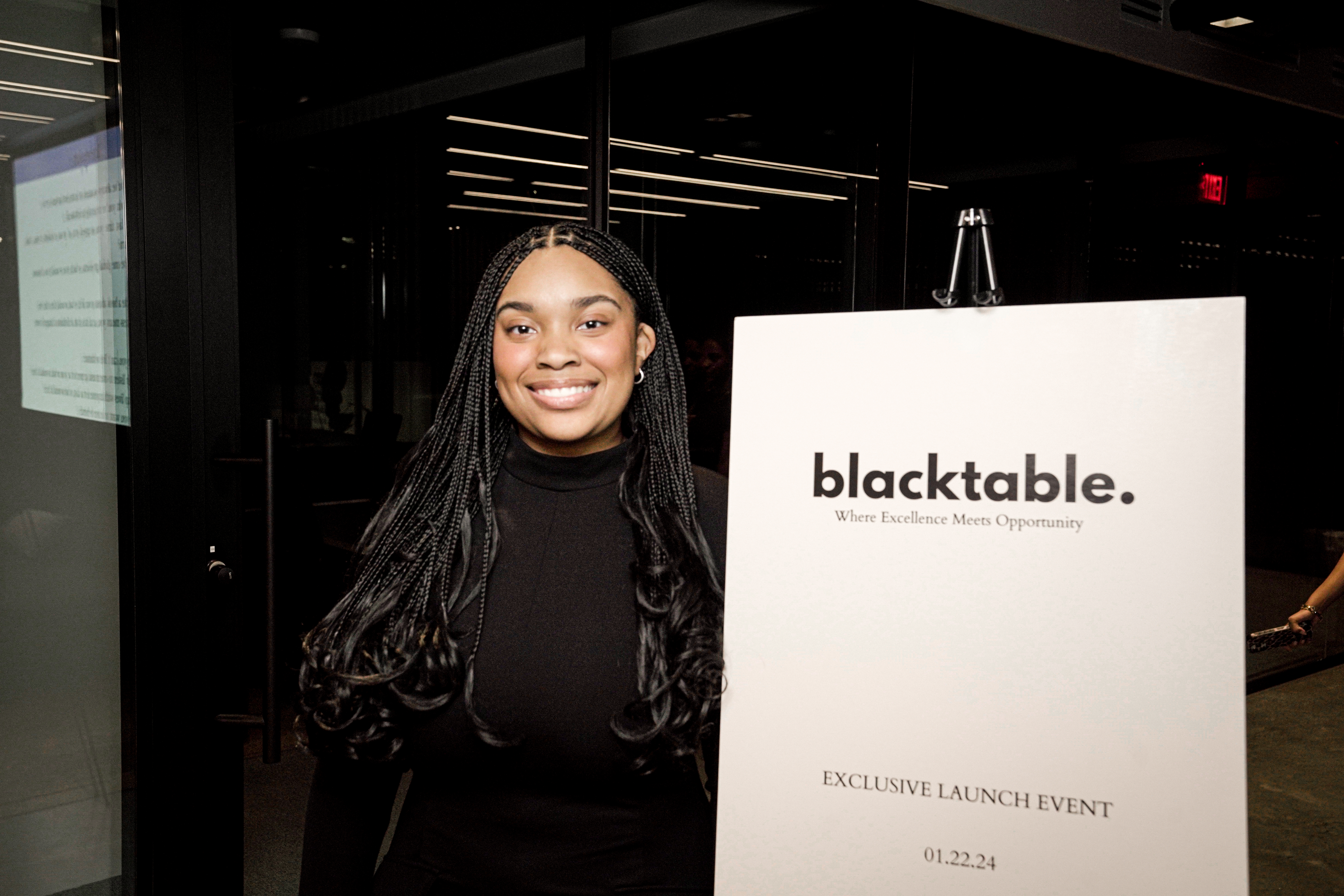 Blacktable founder Ashley Petgrave beside the launch event sign